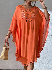 Orange crochet yoke tassel kaftan dress with wide sleeves and a flowy hem.
