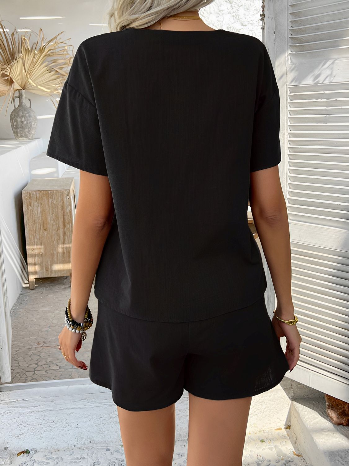 Black linen tie-front top and shorts set with short sleeves and a relaxed fit.