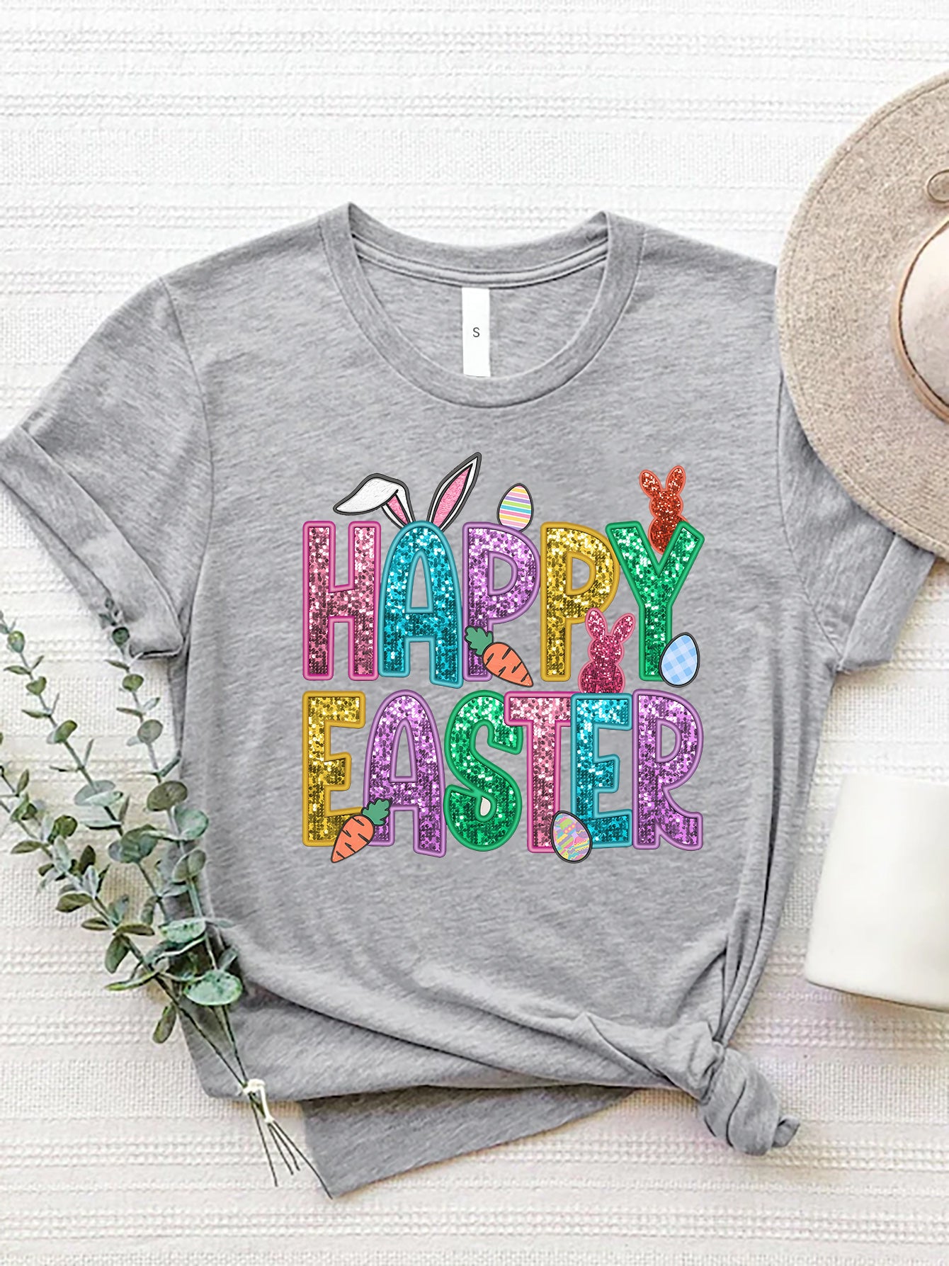 Gray t-shirt with glittery Happy Easter graphic featuring bunnies, carrots, and eggs.