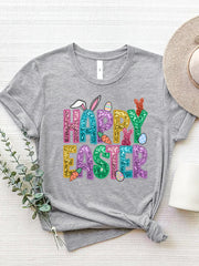 Gray t-shirt with glittery Happy Easter graphic featuring bunnies, carrots, and eggs.