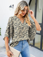 Floral print V-neck blouse with flutter sleeves in 100% polyester.