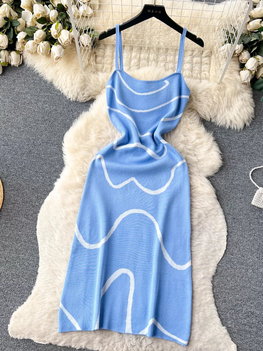 Blue wavy knit midi dress with spaghetti straps and white wave pattern