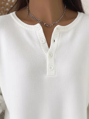 White knit long-sleeve top with button detail at the neckline.