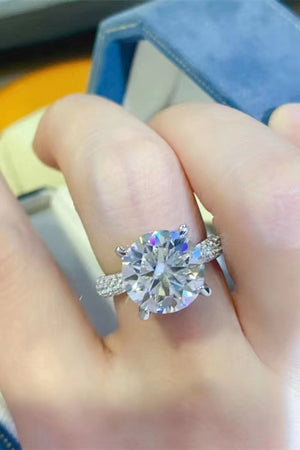 Silver pavé band round moissanite solitaire ring with a large center stone.