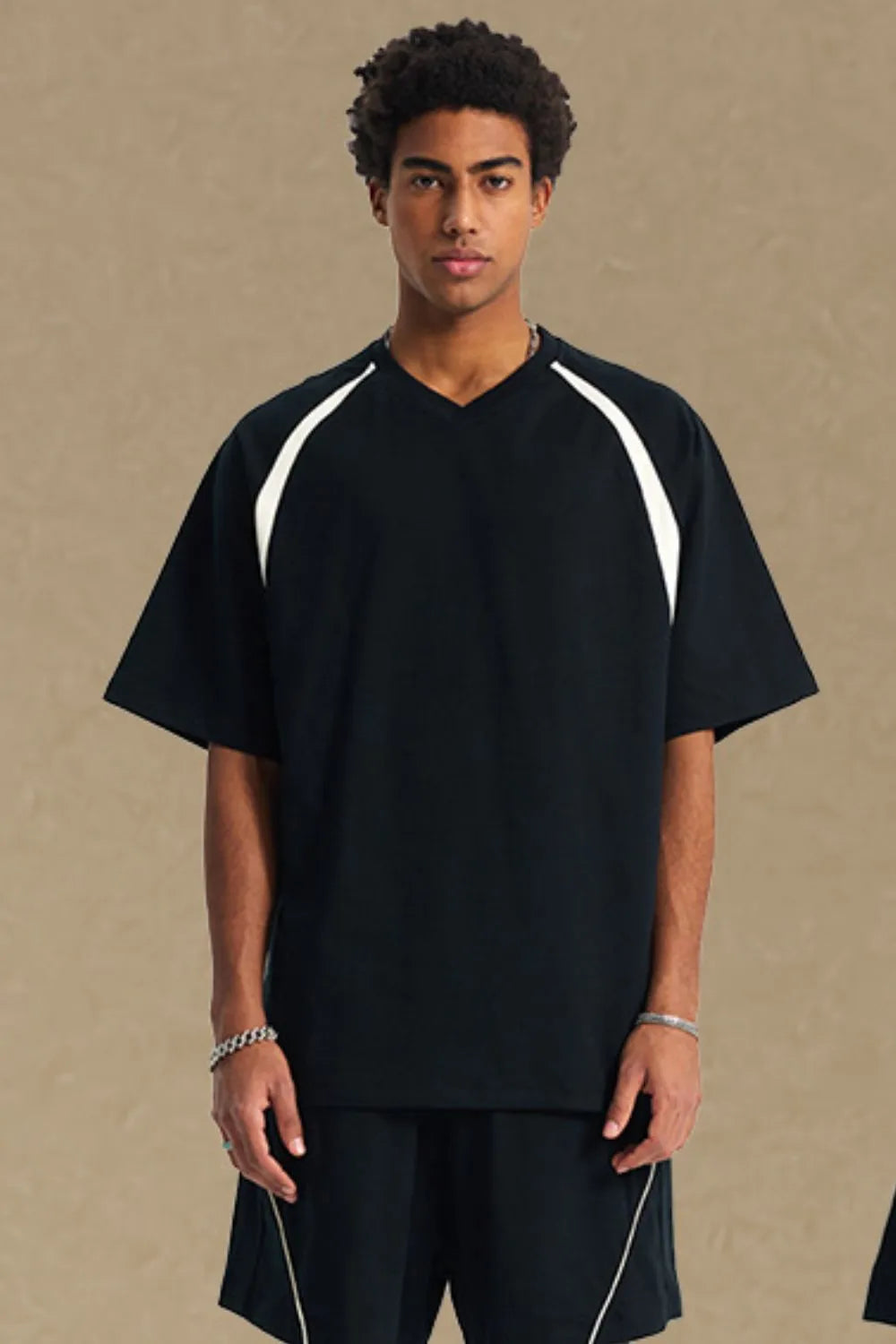 Black V-neck raglan tee with white contrast shoulder details