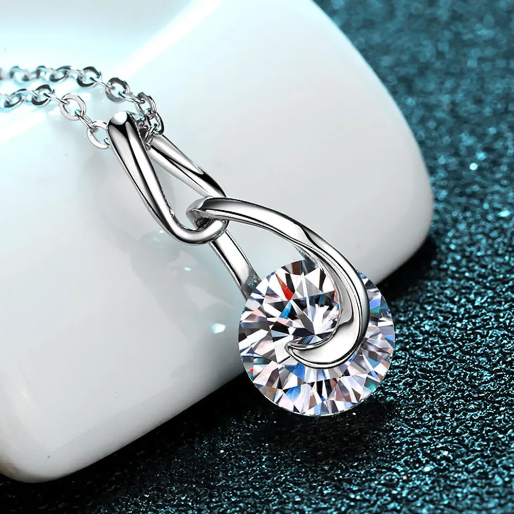 Silver solitaire pendant necklace with a round-cut crystal and a twisted bail.