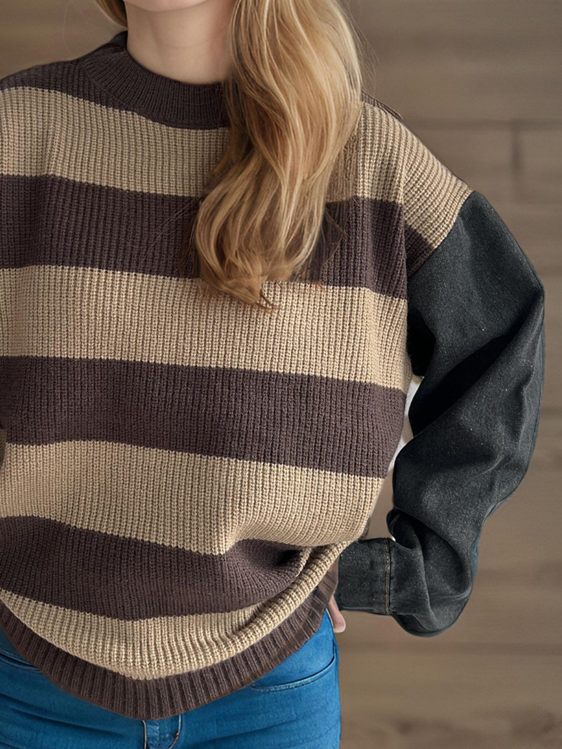 Brown and tan striped knit sweater with black denim sleeves and crew neck.