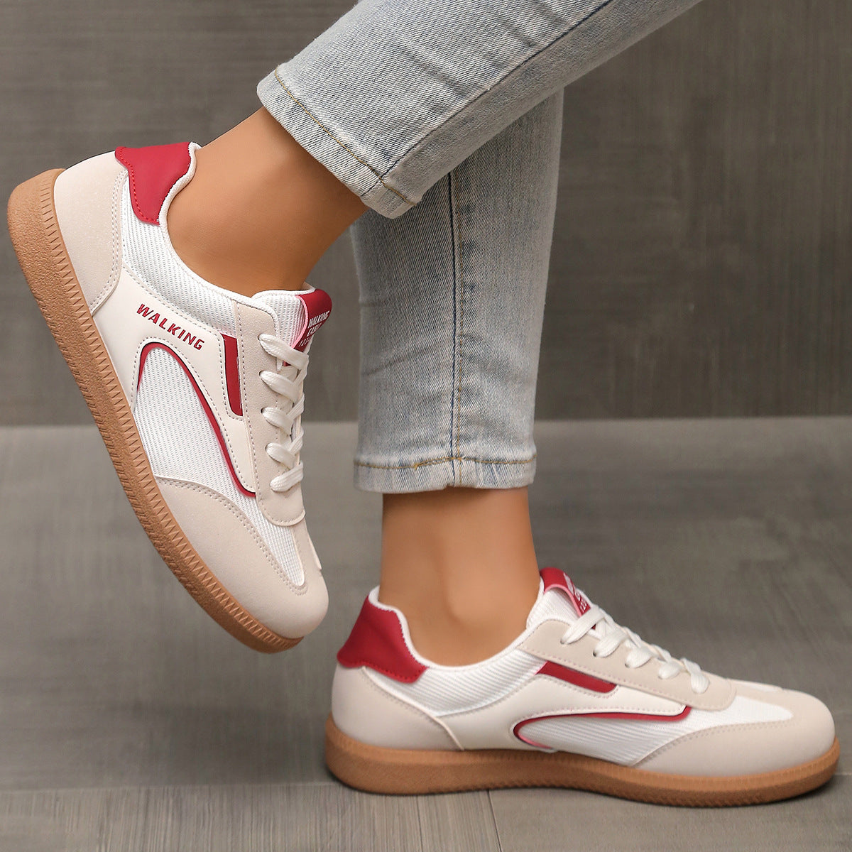 White and red lace-up sneakers with tan soles and "WALKING" text detail.