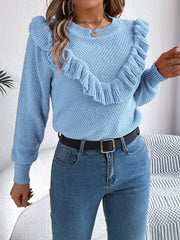 Light blue knit sweater with textured yoke and ruffled trim.