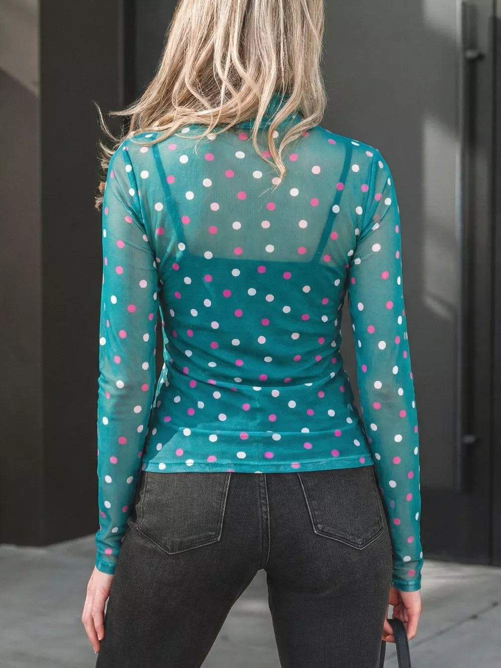Sheer polka dot mock neck shirt in Air Force Blue with pink and white dots, long sleeves.