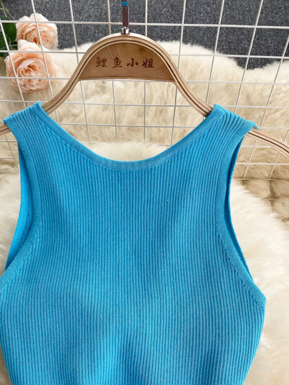 Light blue ribbed knit midi dress with a scoop neck and sleeveless design.