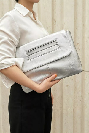 Timeless Envelope Clutch in distressed silver leather with cut-out handle detail.