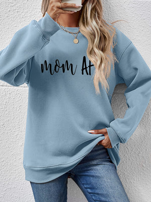 Misty Blue graphic sweatshirt with "mom At" text, crewneck, long sleeves, and ribbed cuffs and hem.