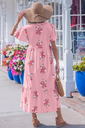 Pink floral cotton midi dress with flutter sleeves and tiered hem.