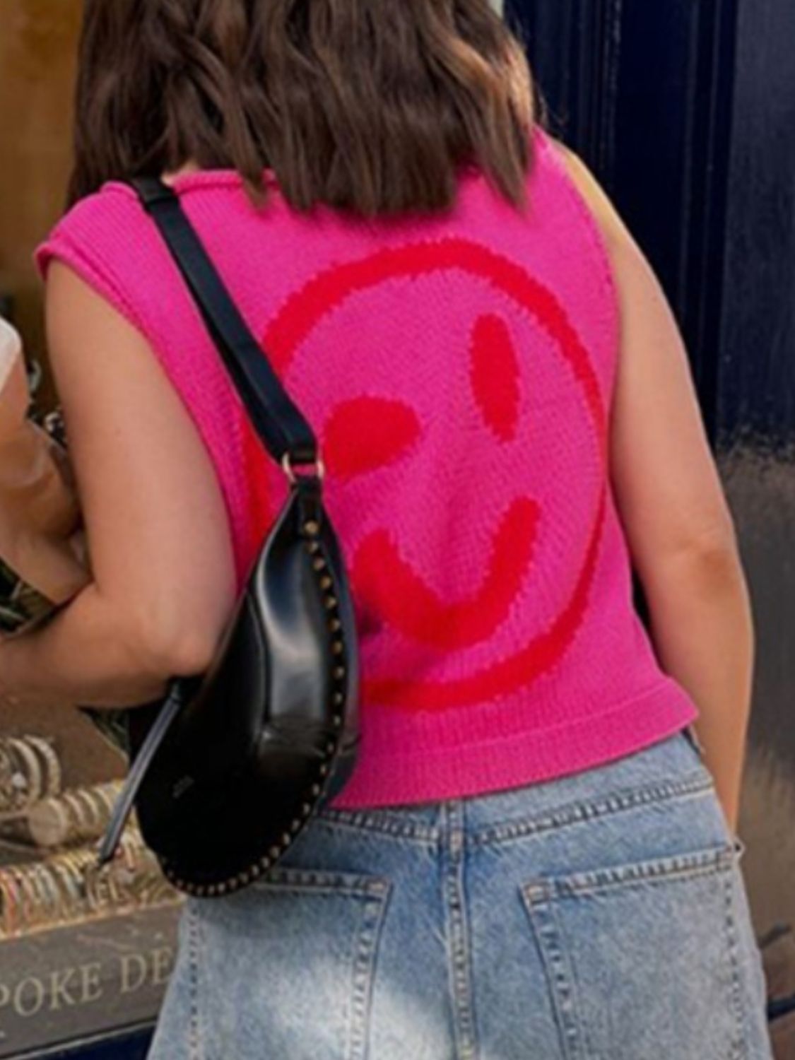 Knit smiley face tank top in hot pink with red graphic detail.