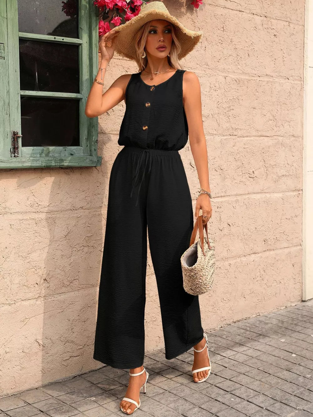 Black wide-leg romper with button detail and drawstring waist, perfect for maternity wear.