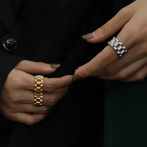 Watch link statement ring in gold and silver, featuring a bold, segmented design.