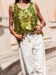 Light Green sequin tank top with frayed neckline and armholes, styled with white pants.