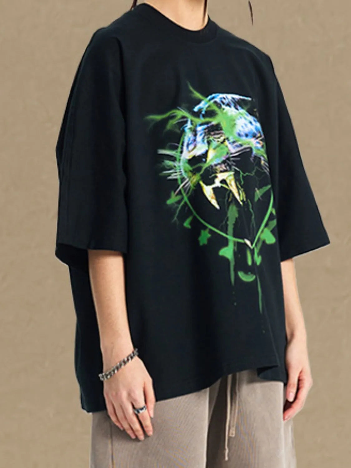 Black oversized tee with electric leopard graphic print and crew neck.