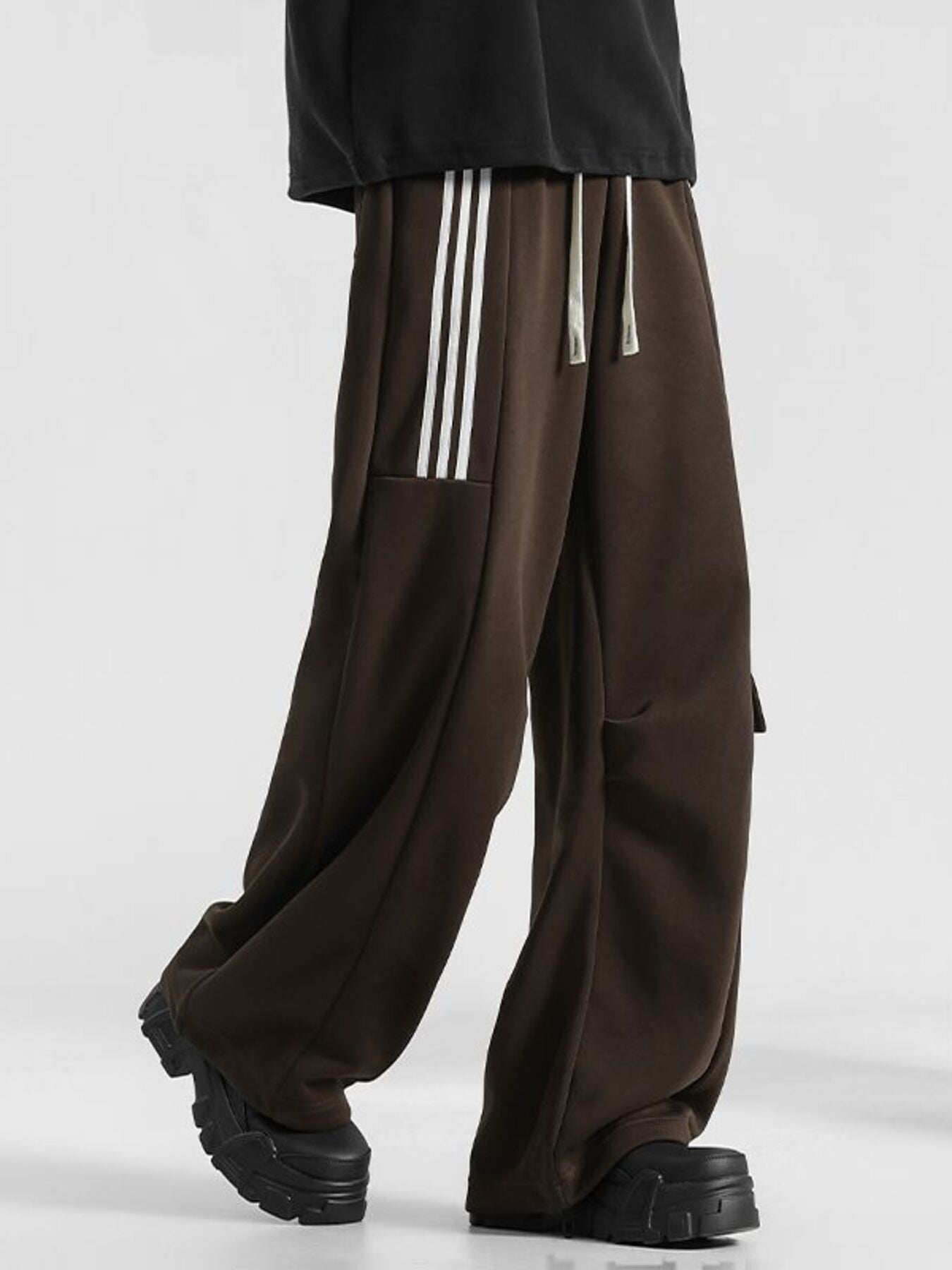 Men's brown loose-fit sweatpants with white side stripes and drawstring