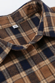 Oversized brown plaid button-up shirt jacket with a classic collar and button closure detail.