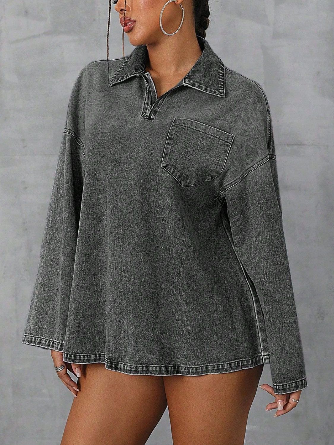 Oversized dark denim polo shirt with a quarter zip, collared neckline, and chest pocket.