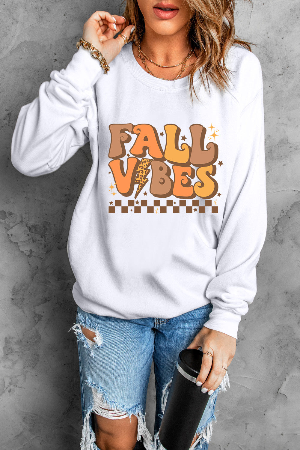 White crewneck sweatshirt with Fall Vibes graphic, long sleeves, and crew neckline.