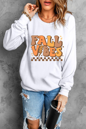 White crewneck sweatshirt with Fall Vibes graphic, long sleeves, and crew neckline.