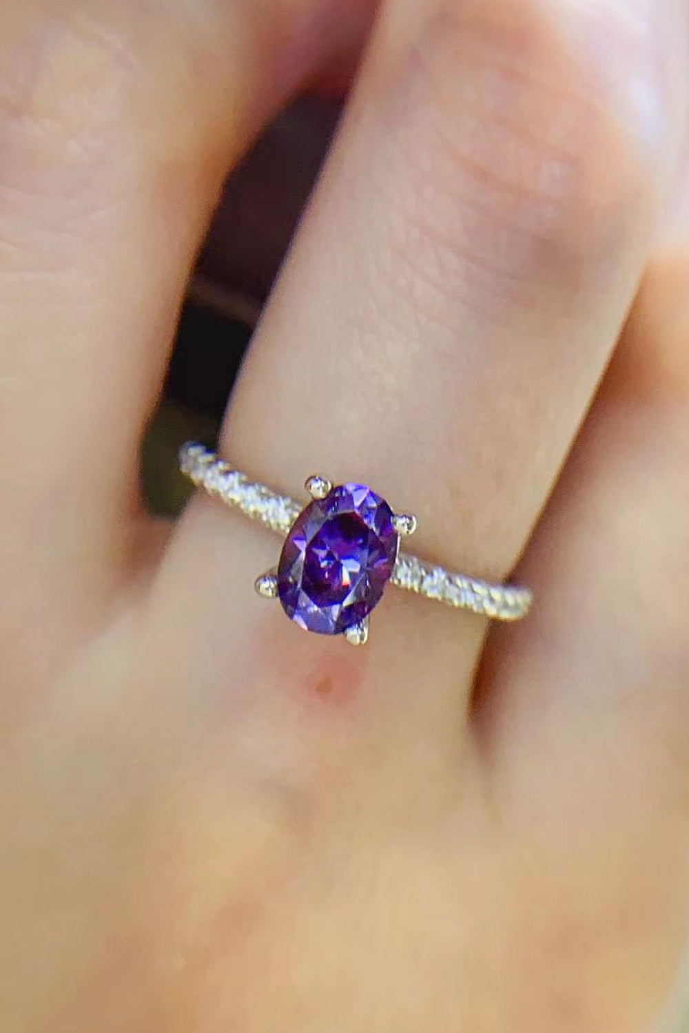 Amethyst oval pavé ring with a bright purple stone and diamond band.