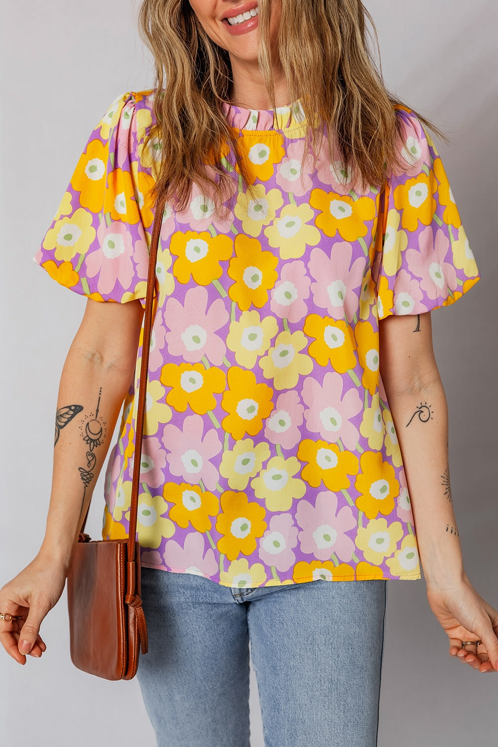 Puff sleeve blouse with ruffle trim in a bold floral print.