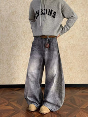Men's vintage wash wide leg jeans in grey denim with curved seams.