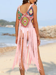 Crochet patchwork cover-up dress in blush pink with multicolor squares and long fringe detail.
