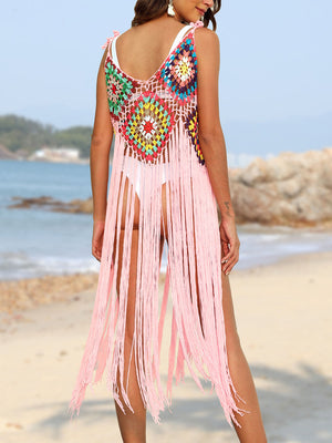 Crochet patchwork cover-up dress in blush pink with multicolor squares and long fringe detail.