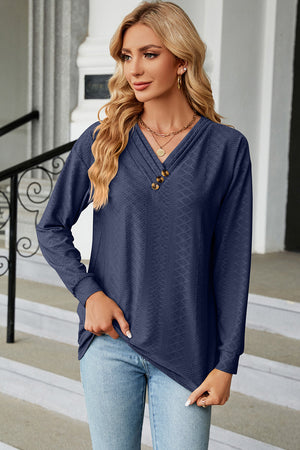 Dark Blue textured henley v-neck top with button detail and long sleeves.
