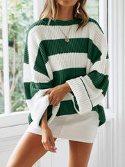 Striped oversized knit sweater in dark green and white with wide sleeves.