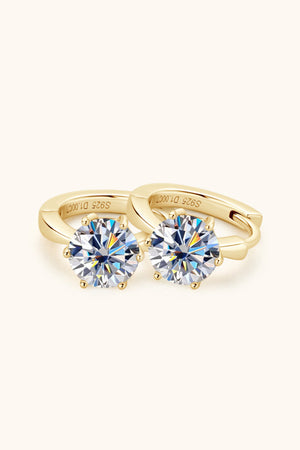 Gold moissanite solitaire huggie hoop earrings with six-prong setting.