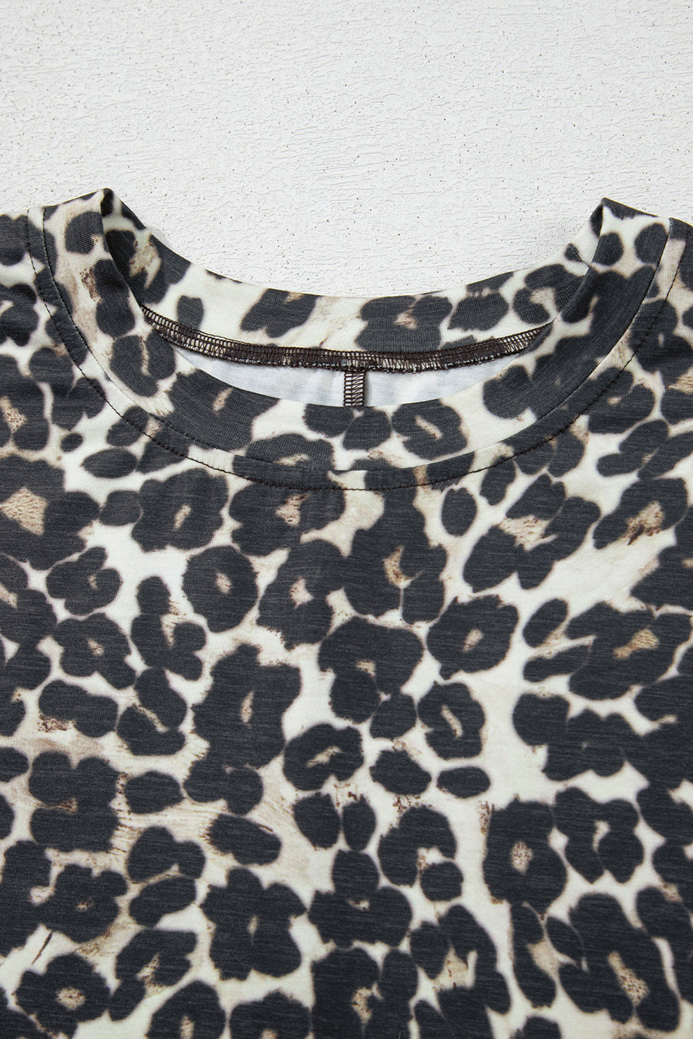 Relaxed leopard print loungewear top with crewneck and detailed stitching.