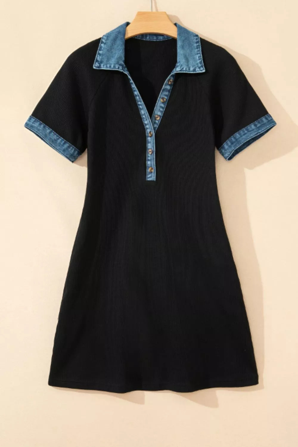 Black ribbed mini dress with short sleeves, denim collar, and button placket.