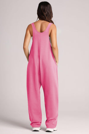 Relaxed fit hot pink jumpsuit with oversized pockets and scoop neckline.