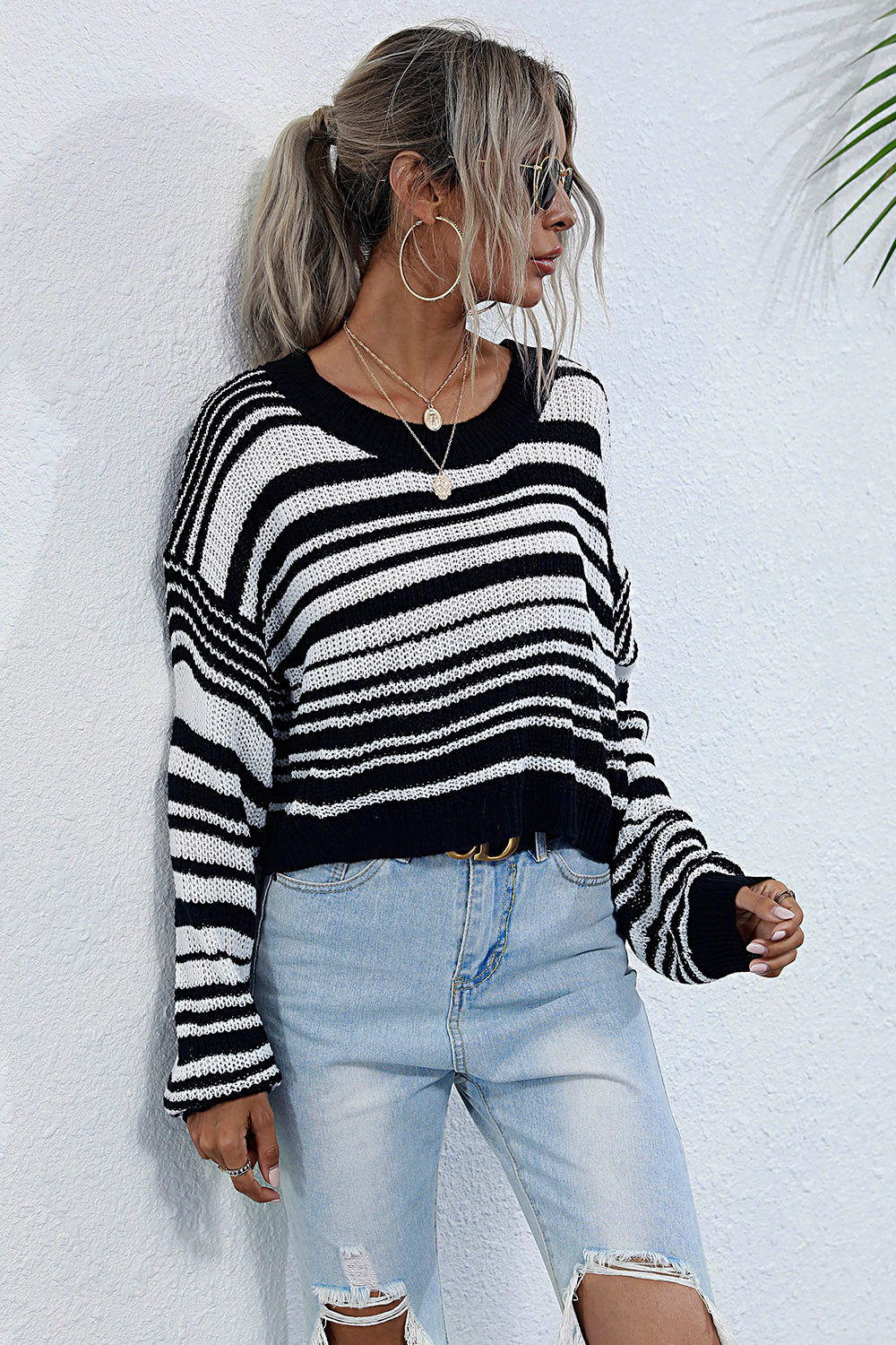 Cropped black and white stripe knit crew neck sweater with relaxed fit.