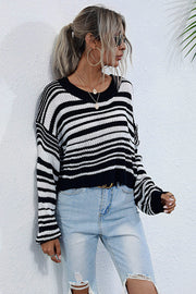 Cropped black and white stripe knit crew neck sweater with relaxed fit.