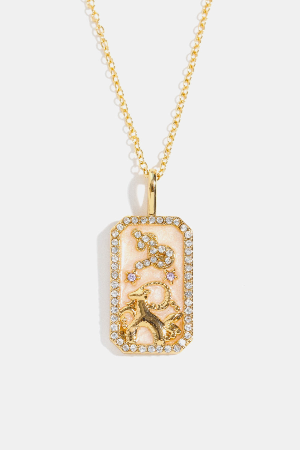 14K gold-plated Capricorn zodiac sign crystal pendant necklace with pink enamel and rhinestones.