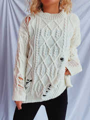 White distressed cable knit sweater with ripped details and a crew neckline.