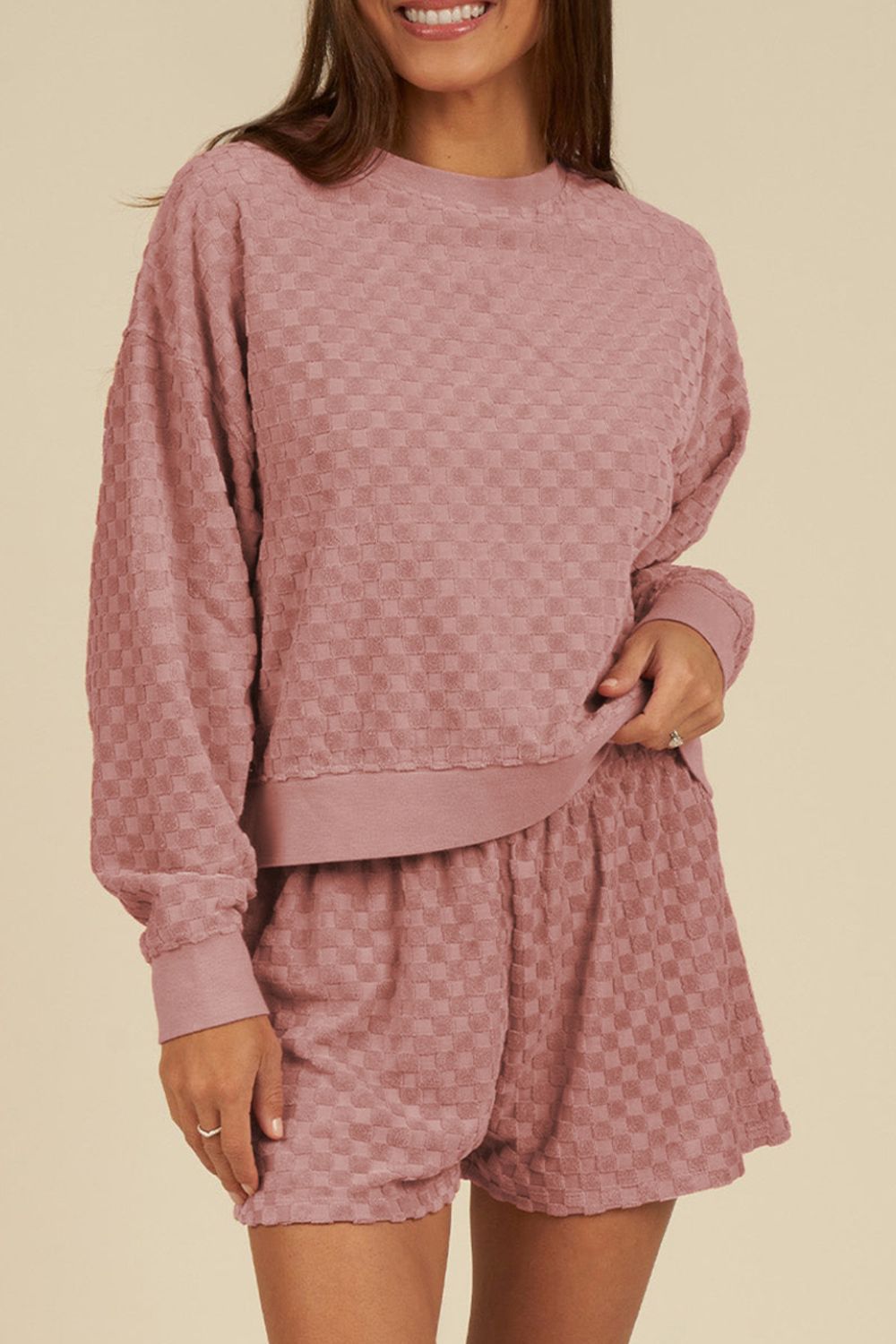 Textured checkered lounge set in dusty pink, featuring a crewneck sweatshirt and shorts.