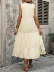 Beige tiered midi sundress with button detail and sleeveless design.