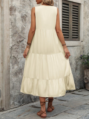 Beige tiered midi sundress with button detail and sleeveless design.