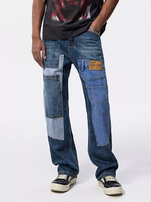 Relaxed fit patchwork jeans in blue denim with distressed details and cargo pockets.