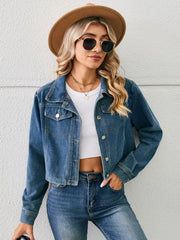 Cropped denim trucker jacket in dusty blue with button closure and chest pockets.