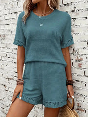 Textured knit set in Air Force Blue with fringe trim on short sleeves and hem.