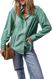 Oversized Sage stripe Oxford shirt with button front and pocket, styled with jeans.